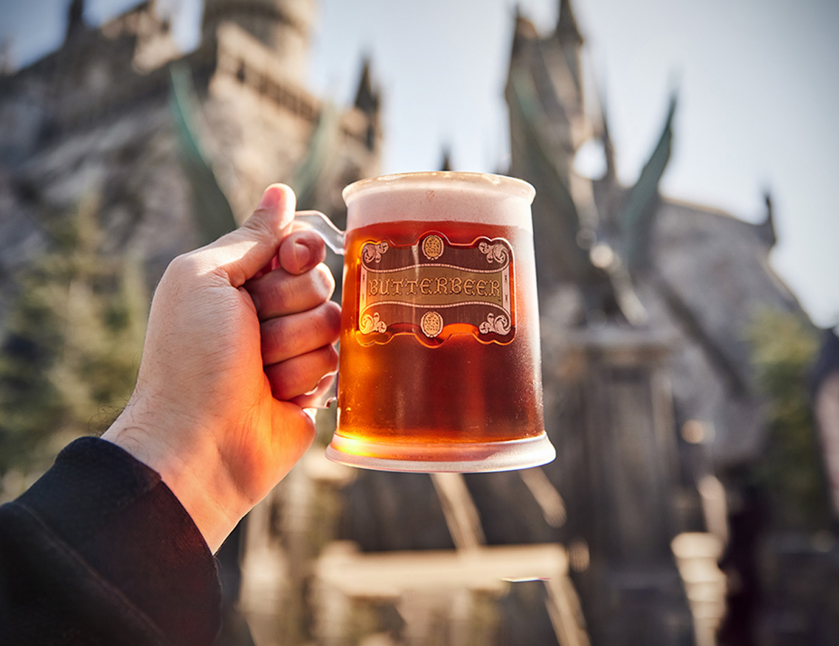 hand holding up mug with butterbeer